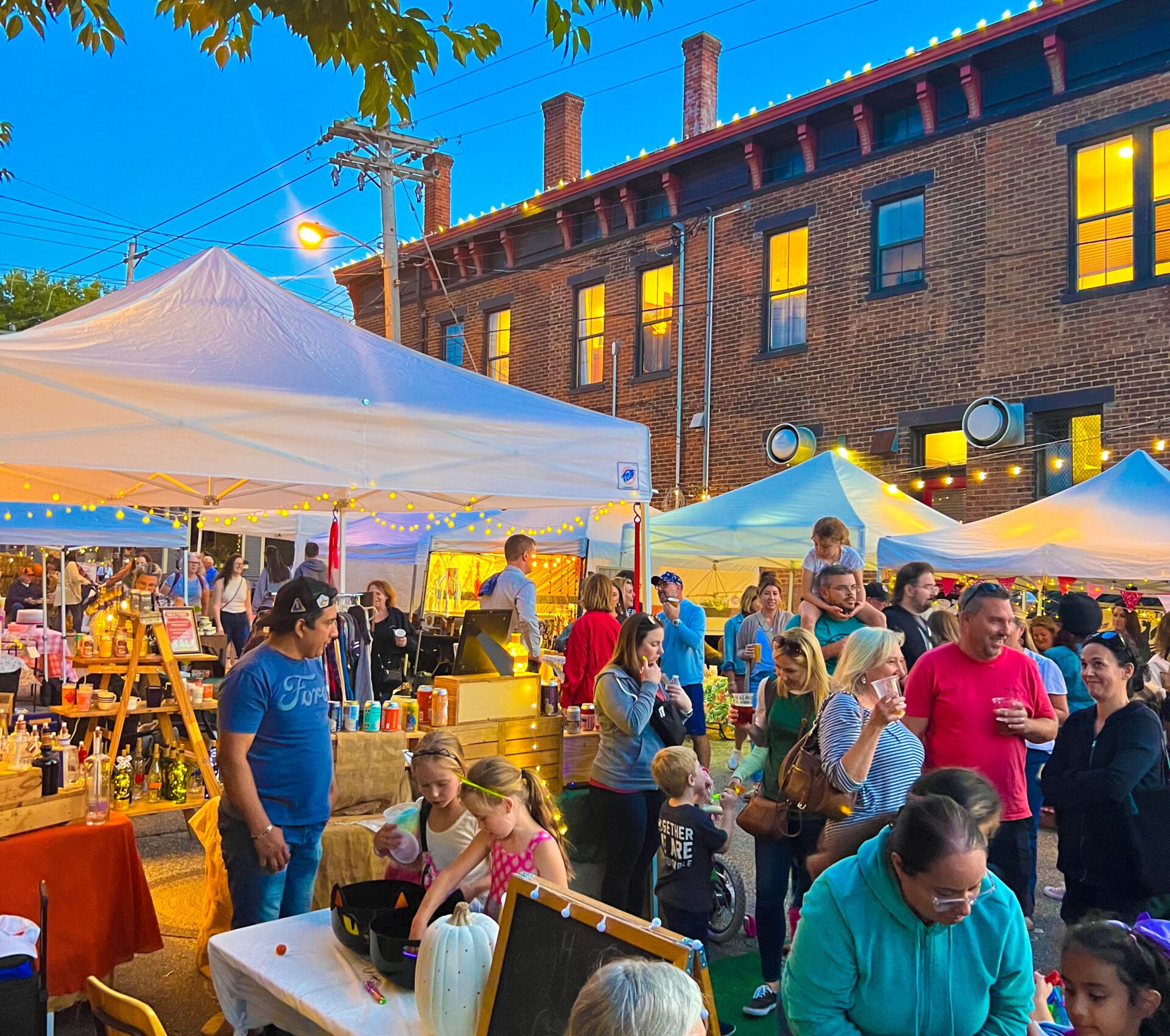Many people at a nighttime craft fair